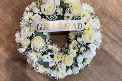 White & green funeral wreath with grandad sash.
