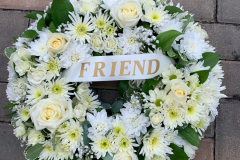 white wreath with white ribbon Friend sash