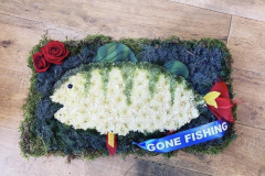 Fishing tribute complete with Gone Fishing sash & red rose spray.