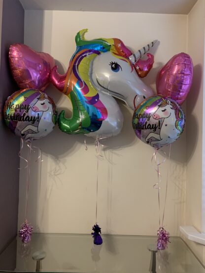 Two pink heart balloons, two round Happy Birthday unicorn balloons & a large unicorn character balloon.