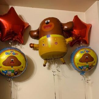 Two red star balloons with two round Duggee ballons & one large Duggee character balloon.