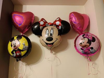 Two pink heart balloons, one round Minnie balloon, one round Mickey balloon & a large Minnie character face.