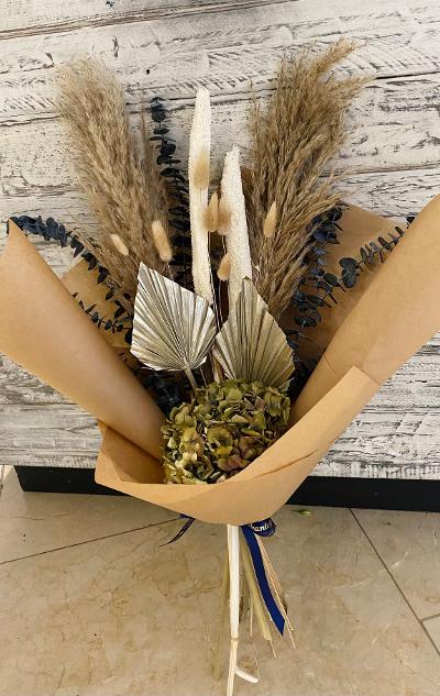 Handtied dried flower bouquet in a mix of natural, green & metallic tones.
