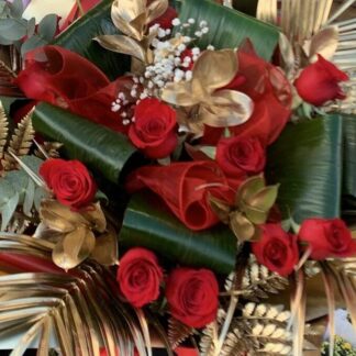 Red roses, gypsophila and lots of mixed foliages including sprayed gold foliages