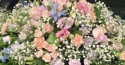 Funeral Coffin Spray with an array of mixed flowers and foliage