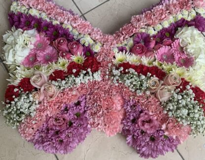 Funeral arrangement made in a butterfly shape out off flowers