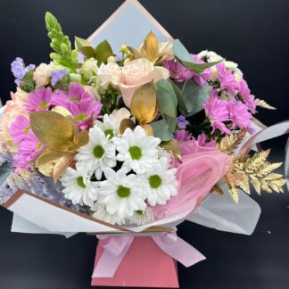 Pink and white bouquet with mixed gold & green foliages.