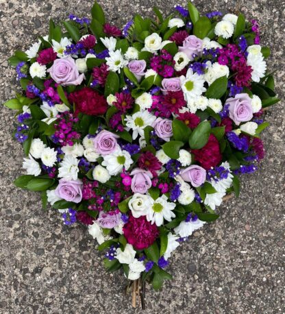 Eco Friendly funeral tribute. Full of mixed flowers in a shape of a heart.